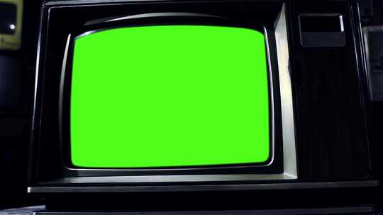 许多旧电视中间带有绿色色度键屏的复古电视机。深色调。多莉出局。