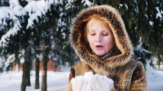 女人向空中扔雪并鼓掌