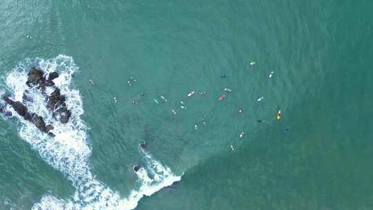 海浪破碎的无人机空中景观和冲浪者在拥挤的