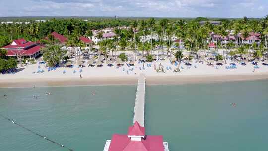 无人机pov飞越多米尼克拉罗马纳巴伊亚普林西比岛酒店和度假村的长码头和凉亭视频素材模板下载