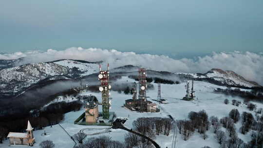 雪山景观，有无线电塔和教堂，周围是光秃秃