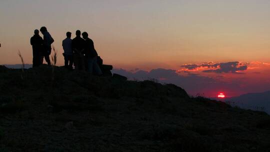 人们站在山顶看日出