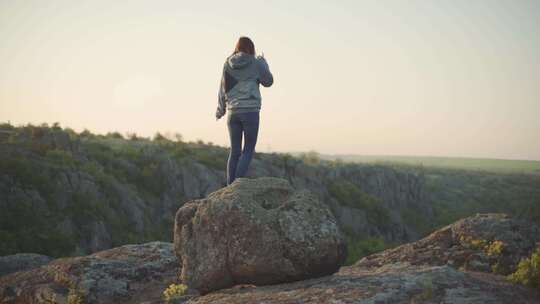 一个年轻的女旅行者在峡谷的山上散步