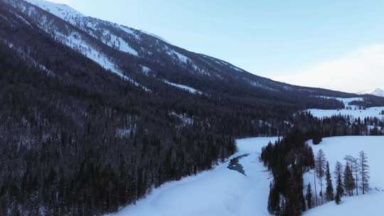 航拍新疆冬季喀纳斯湖雪景雪山森林冰河晨雾