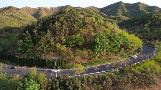 航拍威海里口山的盘山公路和青翠小山