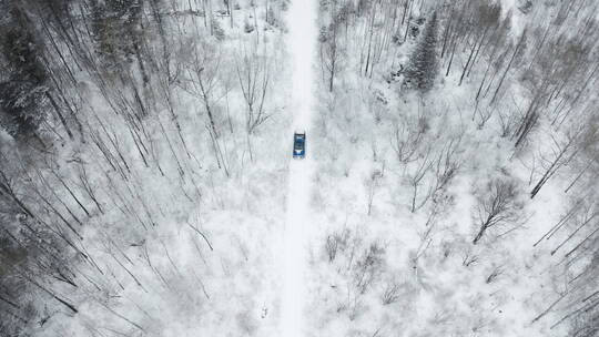 东北冬季大雪中的森林越野车行驶航拍