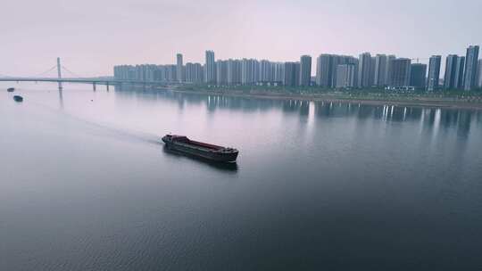 南昌航拍江上货船与城市建筑全景