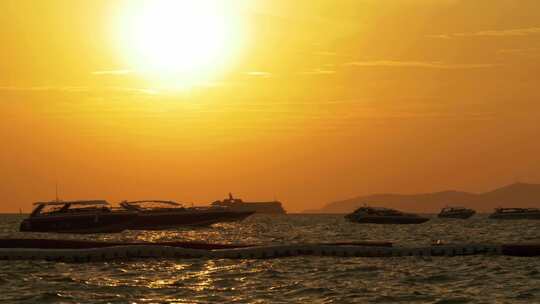 海上的红色日落与剪影船在波浪上摇摆泰国芭