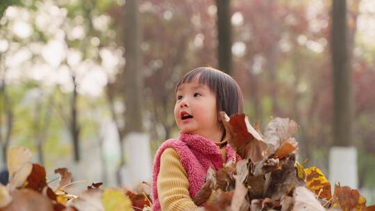 小朋友抛洒秋天的树叶慢镜头