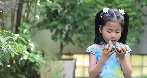 美丽中国儿童端午节拿着粽子 闻粽子笑脸