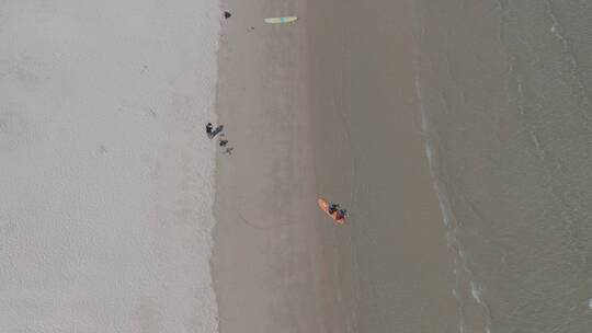 航拍海南三亚后海海滩冲浪游玩视频素材模板下载
