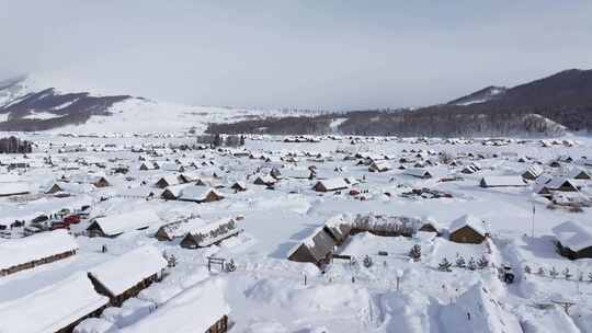 航拍新疆禾木雪景森林雪地小木屋禾木桥雪山