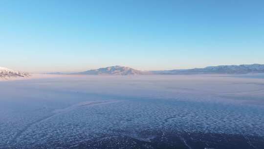 航拍冬季新疆赛里木湖雪山冰湖蓝冰日照金山