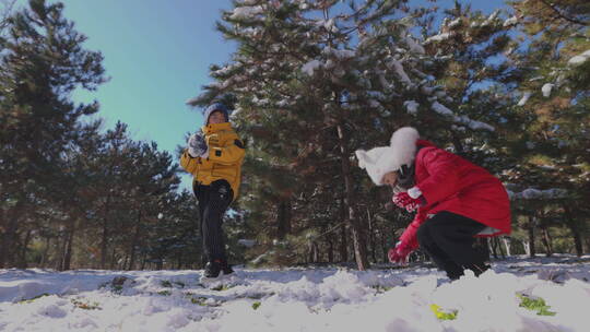 快乐儿童在雪地里打雪仗