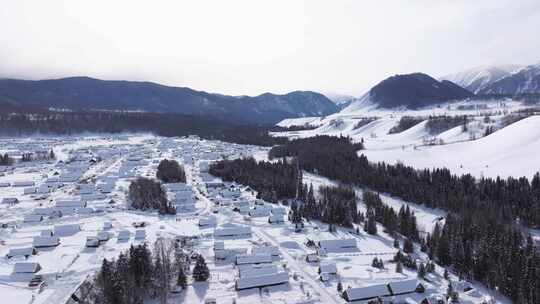 航拍新疆禾木雪景森林雪地小木屋禾木桥雪山