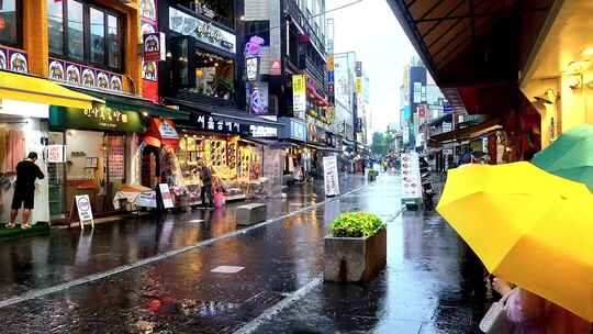 雨中的城市街道，人们拿着雨伞散步