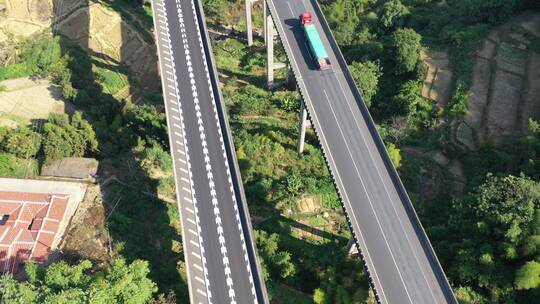 航拍高速公路上行驶的货车汽车高架桥高速路视频素材模板下载