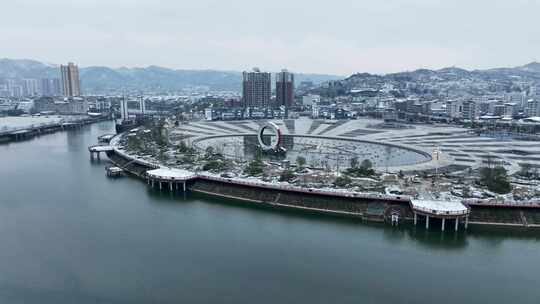 雪后城市河畔广场航拍全景