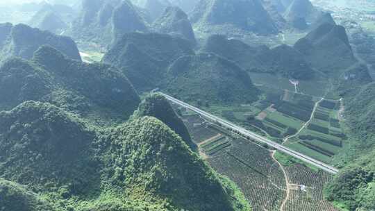 航拍广西层峦叠嶂的大山喀斯特地貌高速隧道