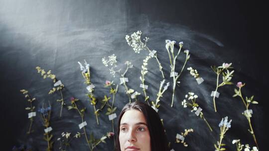 女人站在鲜花墙前