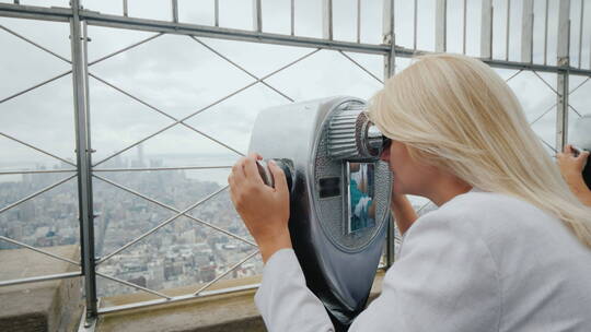 女人透过望远镜看纽约全景