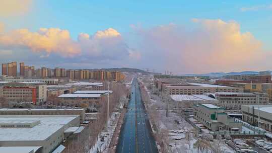 冬季航拍烟台大雪后的城市建筑和晚霞风景