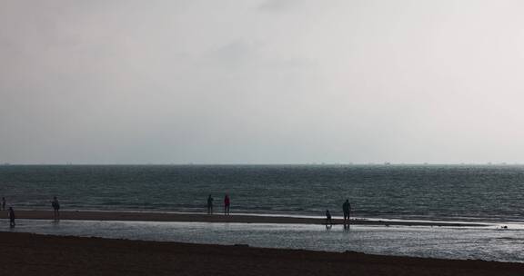 8k实拍清晨海边沙滩上游玩的人群