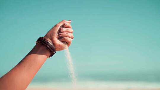 沙子流过女人的手、握不住的沙