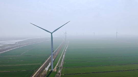 航拍高视角田地间的风力发电涡轮机