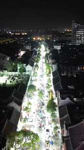 竖版航拍河南开封城市夜景步行街人流