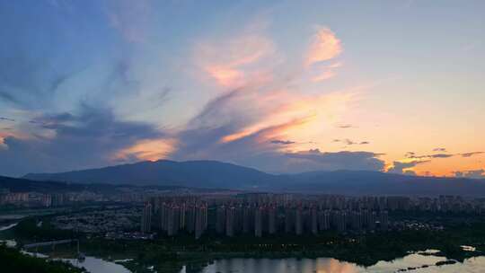 航拍晚霞下的西双版纳景洪市城市风光延时