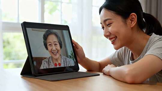 女人通过平板与老人视频通话