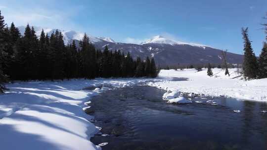 航拍新疆冬季喀纳斯河流晨雾雪山森林雪景