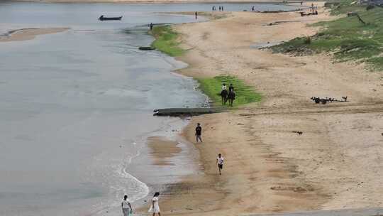 航拍威海市环翠区金海路沙滩上的骑马人