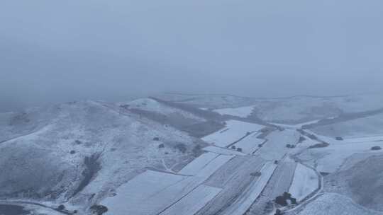 航拍风雪交加的山脉田野