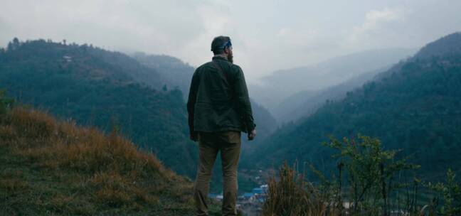 男人站在高山顶眺望