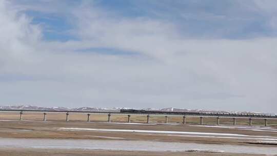 青藏铁路火车行驶于雪山下