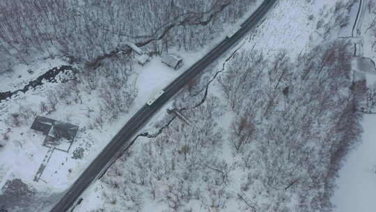 航拍东北长白山冬天森林马路车流俯拍