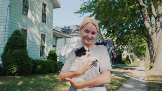 女人怀里抱着小狗在户外行走视频素材模板下载