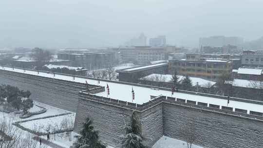 航拍陕西省西安市西安古城城楼大雪纷飞景观