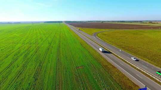 公路运输的卡车树林贯穿草原的道路高速公路