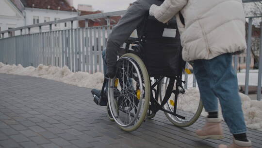 轮椅上的残疾人和朋友在散步视频素材模板下载