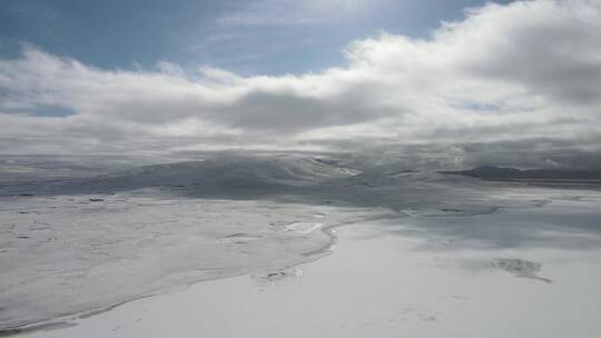 航拍云层下雪后高原风景