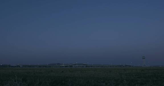 大兴机场航站楼外日转夜 亮灯 飞机滑行经过