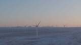 航拍新疆阿勒泰冬季雪原夕阳晚霞戈壁风电场高清在线视频素材下载