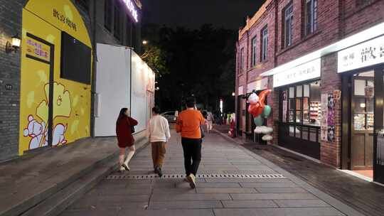 夜晚商业街行人漫步街道的场景