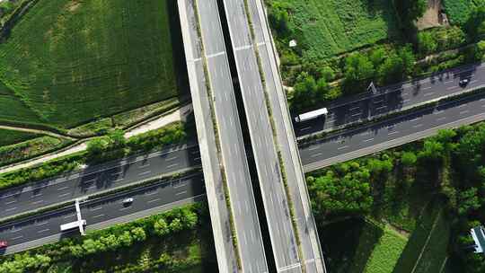 4K航拍在农村穿行而过的城市高速路