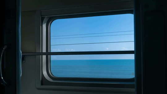 火车车厢内透过窗户看海洋