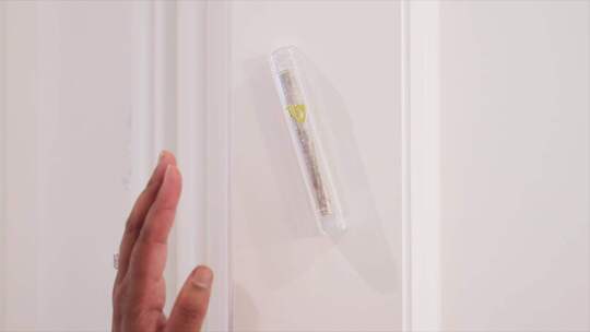 一只手触摸墙上的Mezuzah