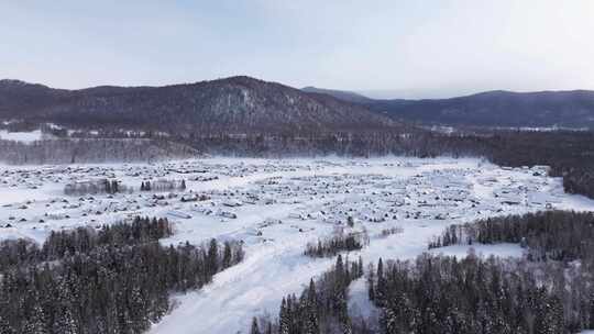 航拍新疆禾木雪景森林雪地小木屋禾木桥雪山